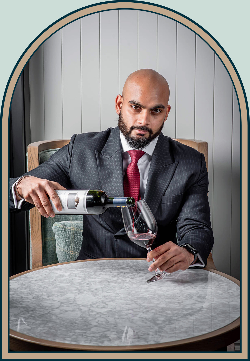 Portrait of General Manager Gagan Singh pouring a glass of wine